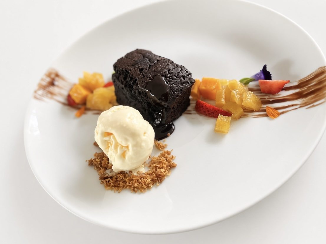 Warm chocolate pudding with vanilla ice cream and fresh fruit at Taprobane Table, Colombo