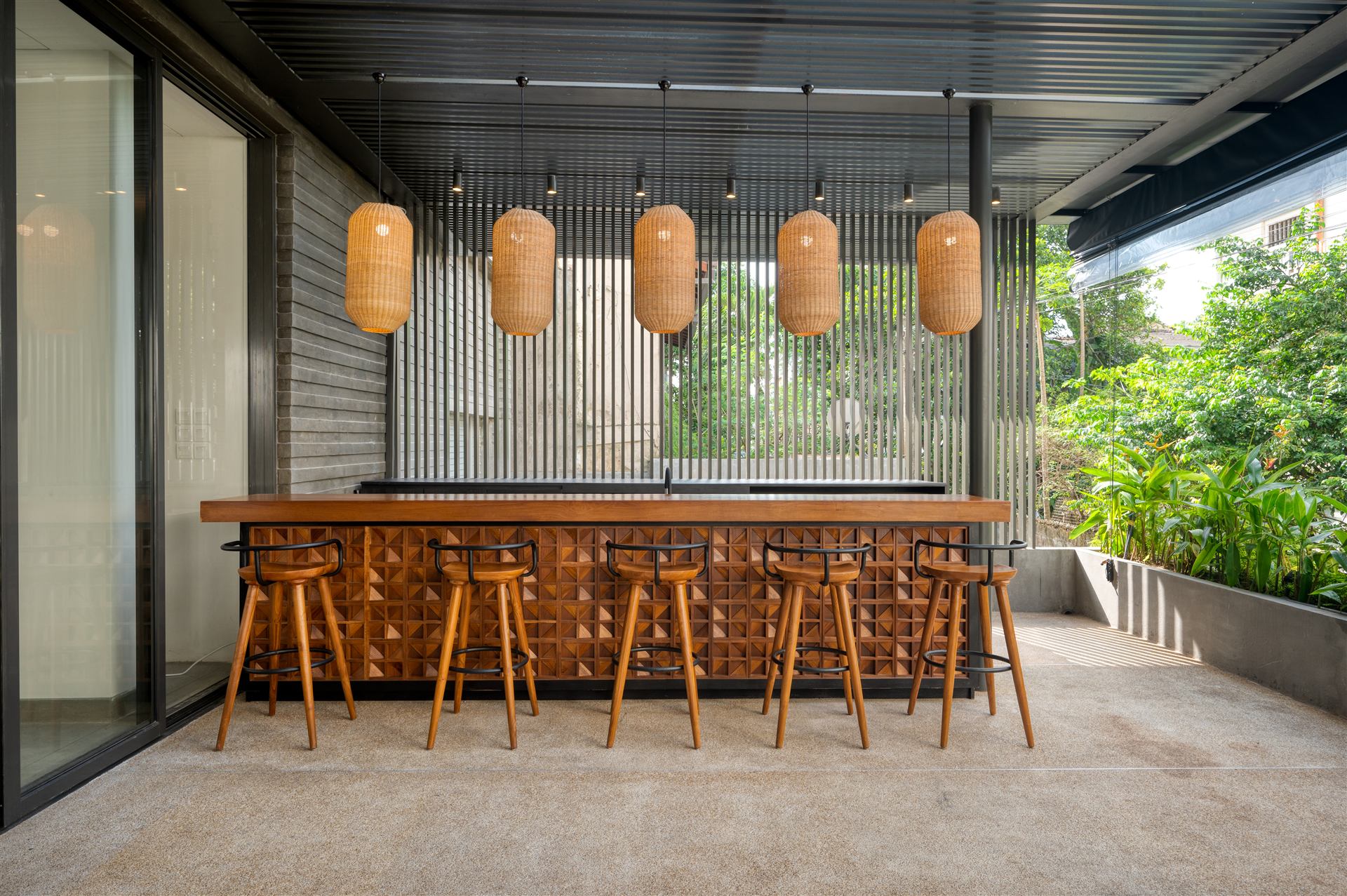 Terrace bar with rattan pendant lights and timber counter