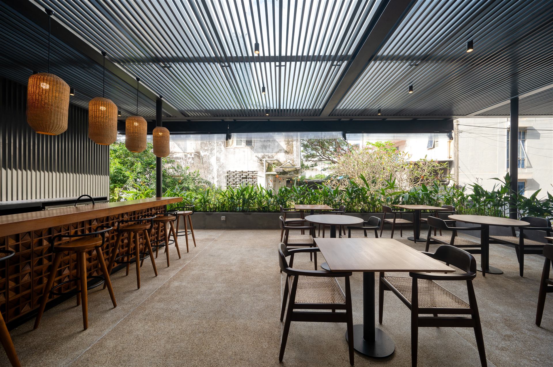 Taprobane Table open-air dining terrace with rattan pendant lights