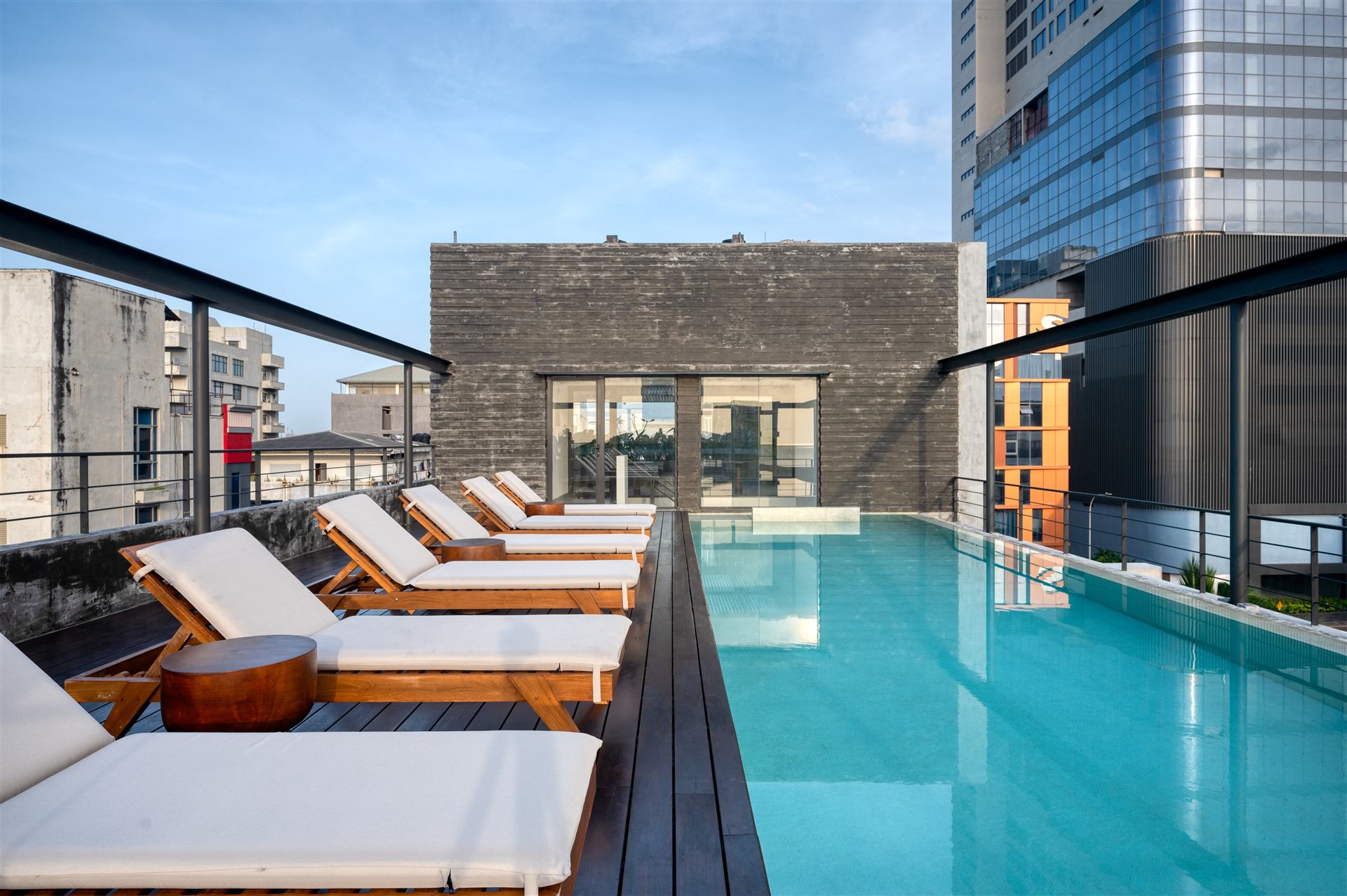 Pool loungers beside the stone feature wall