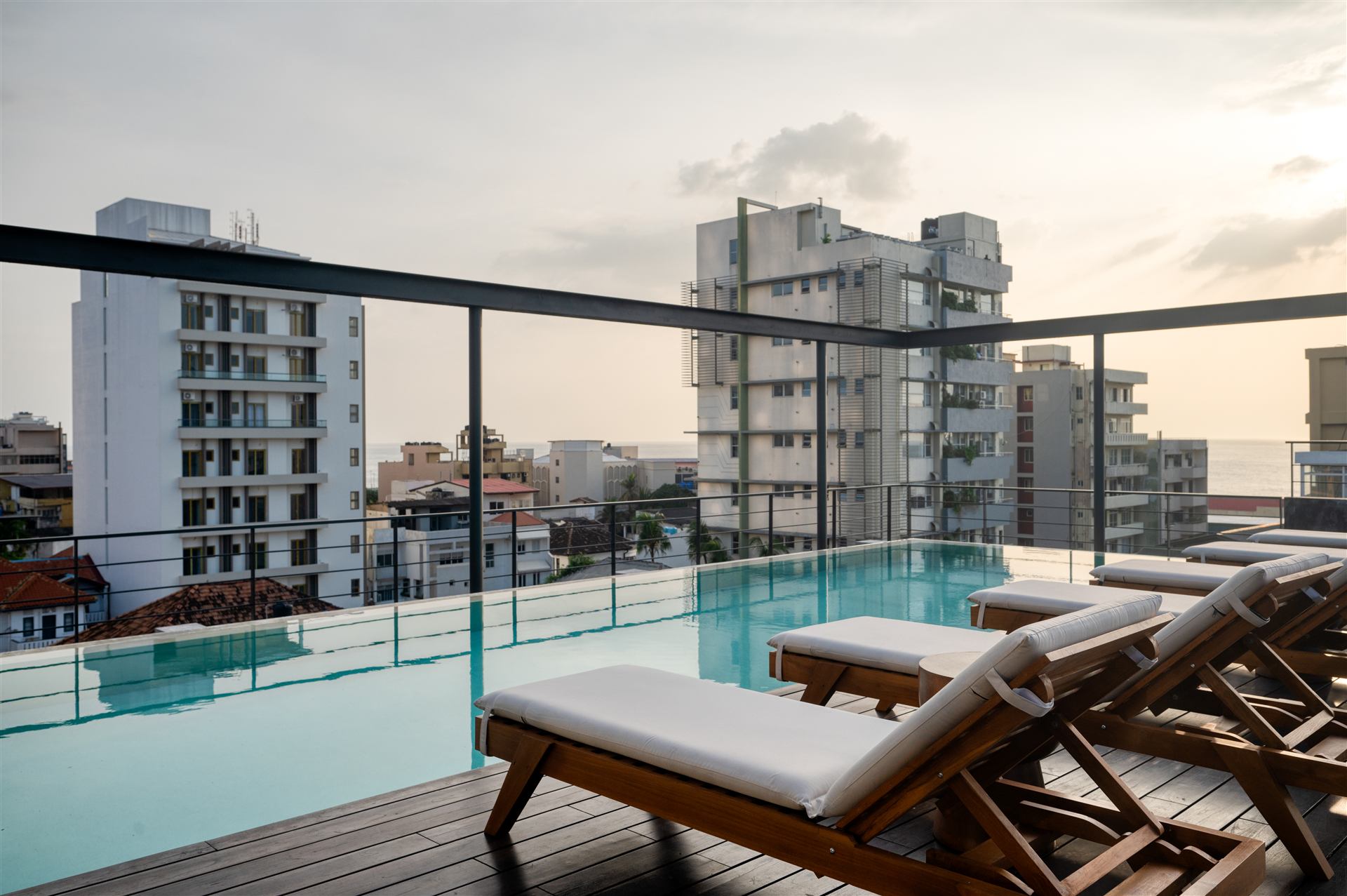 Loungers on the pool deck overlooking the city